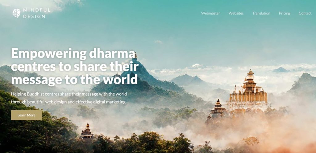 Dharma center websites | View of mountains and clouds with temple in the distance